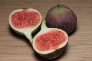 figs, one whole purple fig and two open halves