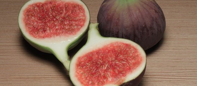 figs, one whole purple fig and two open halves