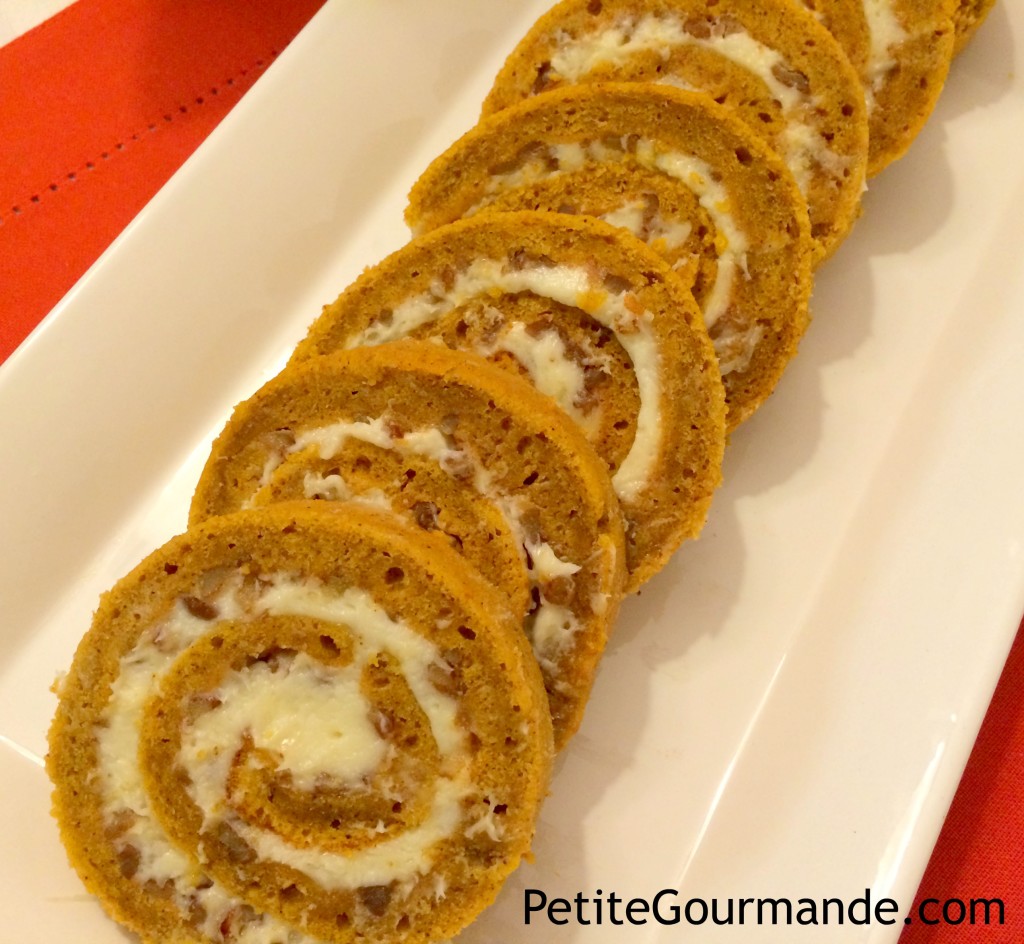 pumpkin roll sliced into pinwheels and arranged in a row in a white platter