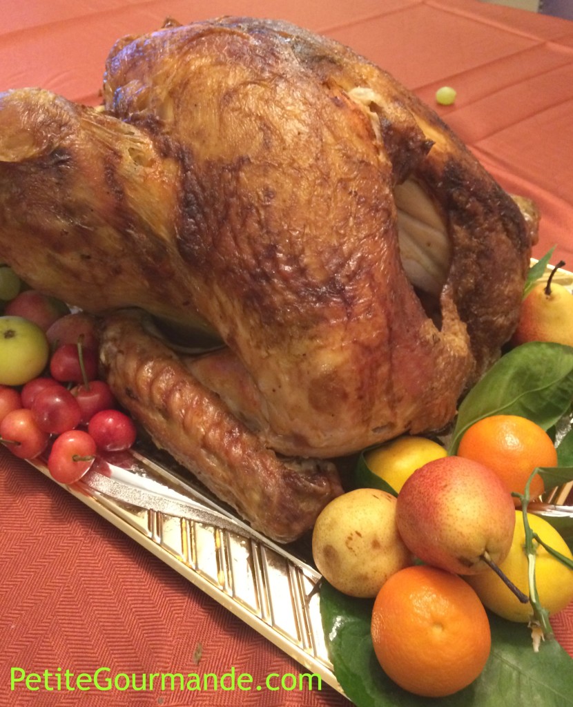 Holiday Roasted Turkey on platter with mandarins, grapes, and baby pears